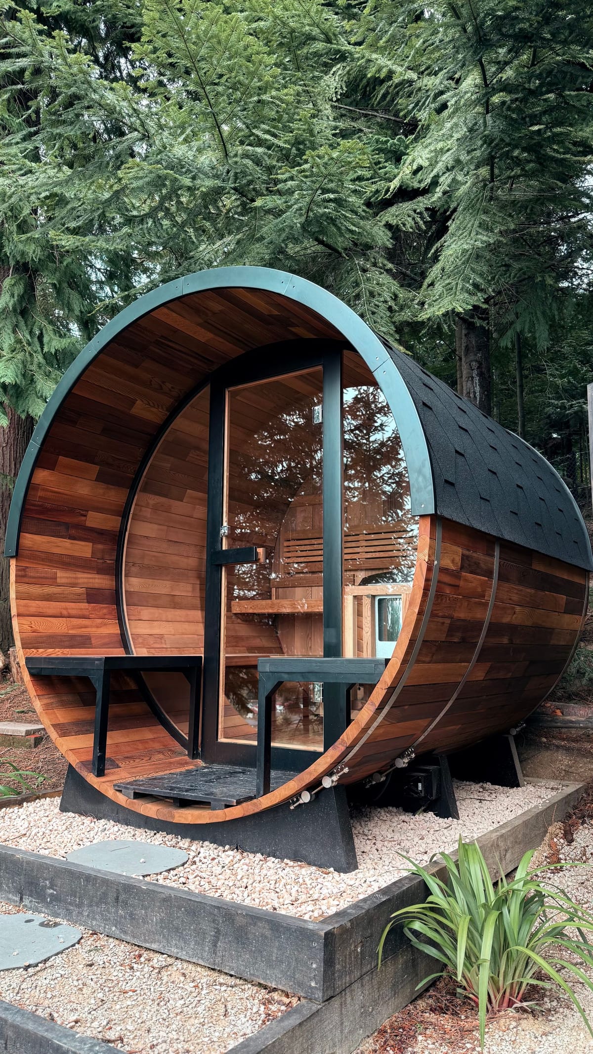 Rustic cedar barrel sauna in a forest garden setting