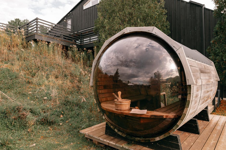 Wooden barrel sauna positioned on a UK beach with the sea in the background